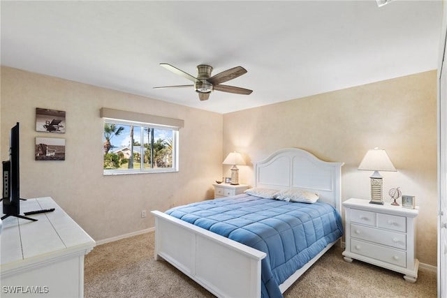 bedroom featuring light carpet, ceiling fan, and baseboards