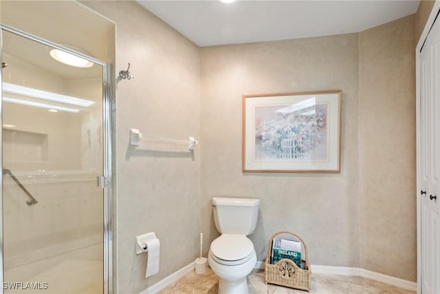 full bathroom featuring a stall shower, tile patterned flooring, baseboards, and toilet