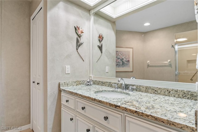 full bath featuring a closet and vanity