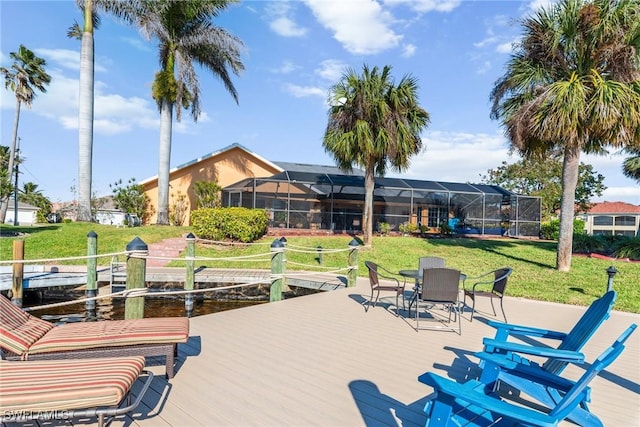 view of patio / terrace featuring a lanai and a dock