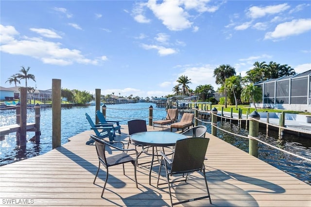 dock area featuring a water view and glass enclosure