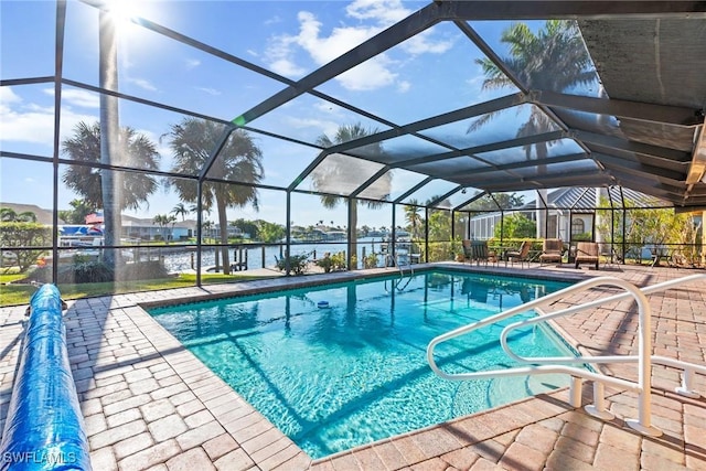 outdoor pool with a patio area, a water view, and a lanai