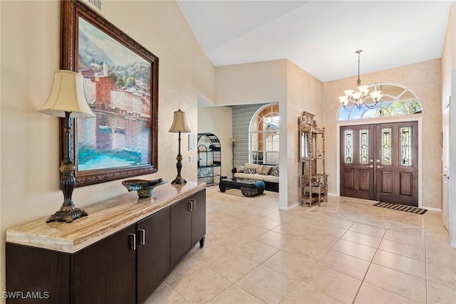 tiled foyer with a notable chandelier