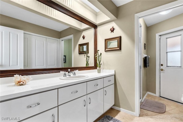 bathroom with tile patterned floors, vanity, and baseboards