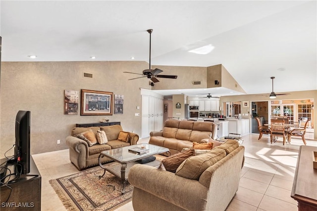 living area with light tile patterned floors, visible vents, high vaulted ceiling, and recessed lighting