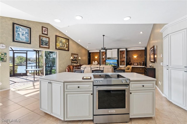 kitchen featuring open floor plan, light countertops, vaulted ceiling, a center island, and stainless steel electric range oven