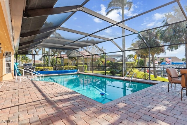 view of pool with a lanai, a patio area, and a covered pool