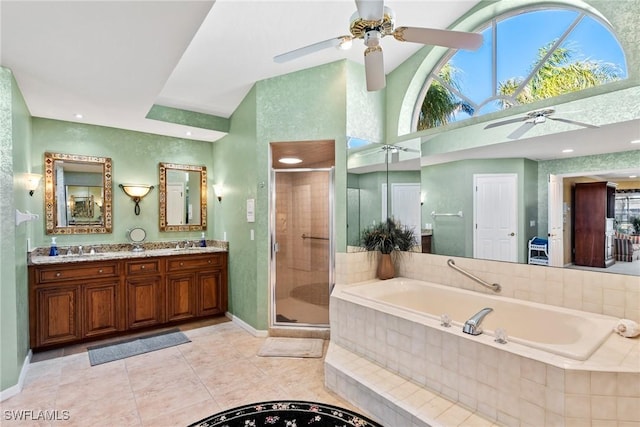 bathroom featuring a garden tub, double vanity, a sink, a shower stall, and tile patterned flooring