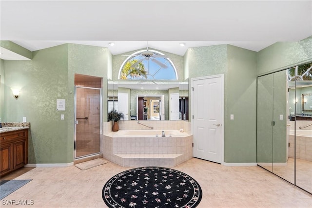 full bath with a garden tub, lofted ceiling, vanity, a shower stall, and baseboards