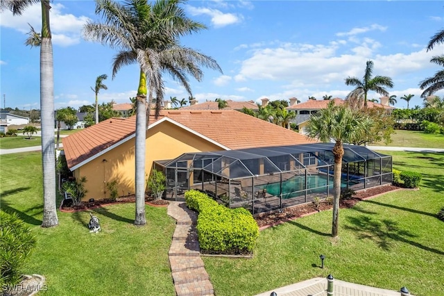 outdoor pool with a lawn and a lanai