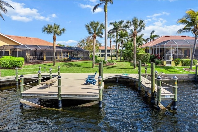 dock area with glass enclosure, a yard, a water view, and boat lift