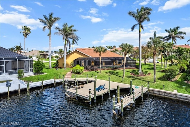 dock area featuring glass enclosure, a yard, and a water view