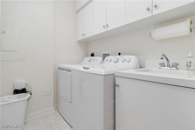 laundry room featuring cabinets, electric panel, sink, and independent washer and dryer