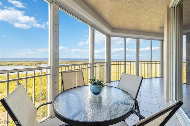 sunroom / solarium with a water view