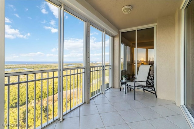 unfurnished sunroom with a water view and plenty of natural light