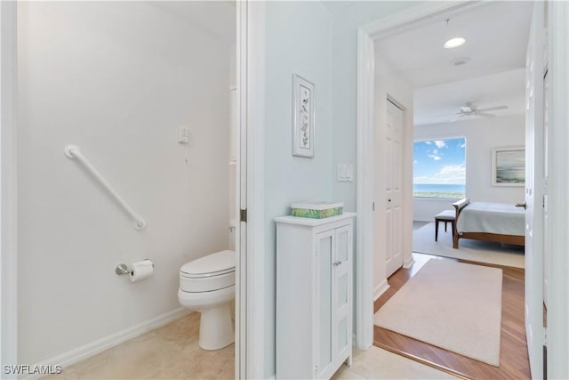 bathroom featuring ceiling fan and toilet