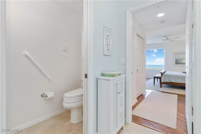 1001 Arbor Lake Dr Unit 1202, Naples, FL 34110 - bathroom featuring toilet, a ceiling fan, baseboards, a water view, and connected bathroom