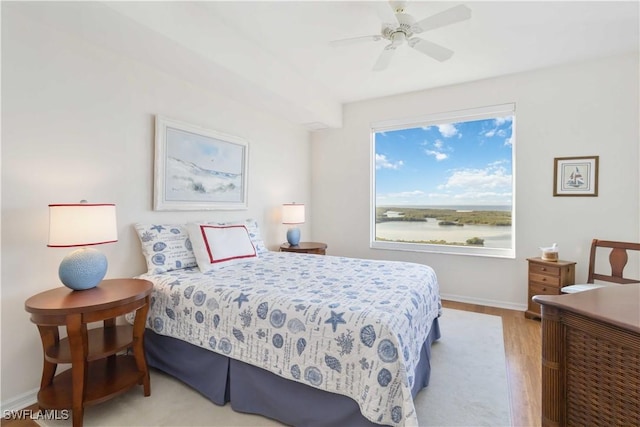 bedroom with light hardwood / wood-style floors and ceiling fan