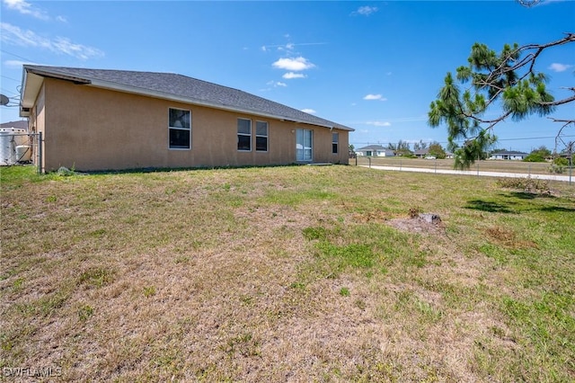 back of house with a yard