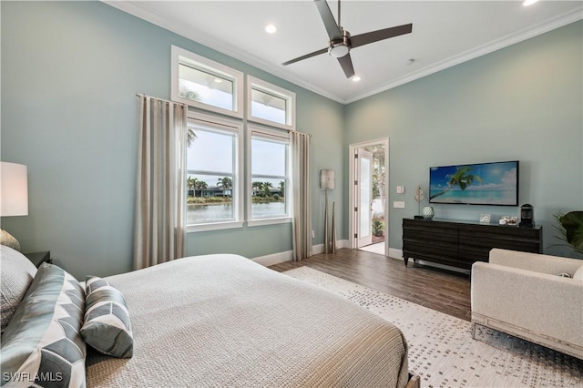 bedroom with crown molding, ceiling fan, and light hardwood / wood-style floors