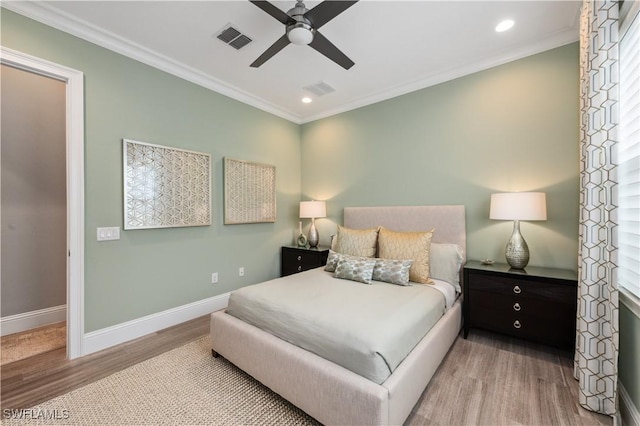 bedroom with ornamental molding, ceiling fan, and light hardwood / wood-style flooring