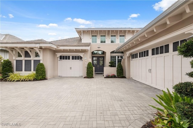 view of front of house with a garage and french doors