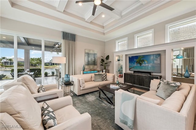 living room with ceiling fan, beam ceiling, a towering ceiling, a water view, and coffered ceiling