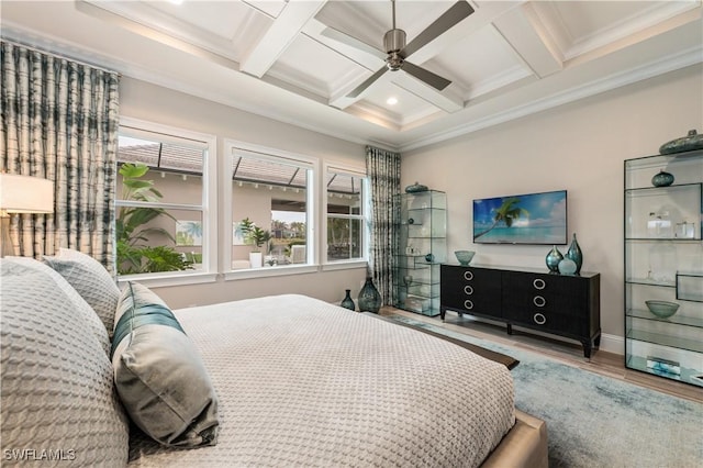 bedroom with multiple windows, hardwood / wood-style flooring, coffered ceiling, and beam ceiling