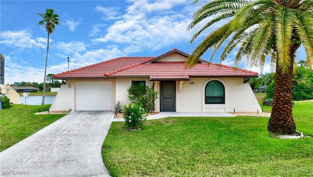 mediterranean / spanish-style home featuring a garage and a front lawn