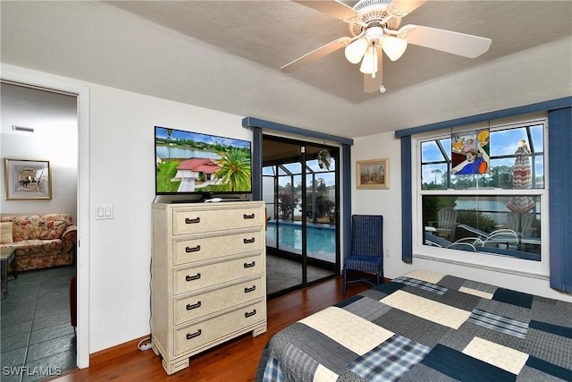 bedroom featuring dark wood-type flooring, access to outside, and ceiling fan