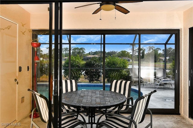 sunroom / solarium featuring ceiling fan and plenty of natural light