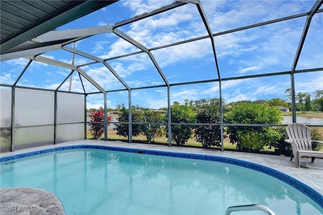 view of swimming pool featuring a lanai and a patio