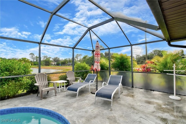 view of patio / terrace with a lanai and a water view