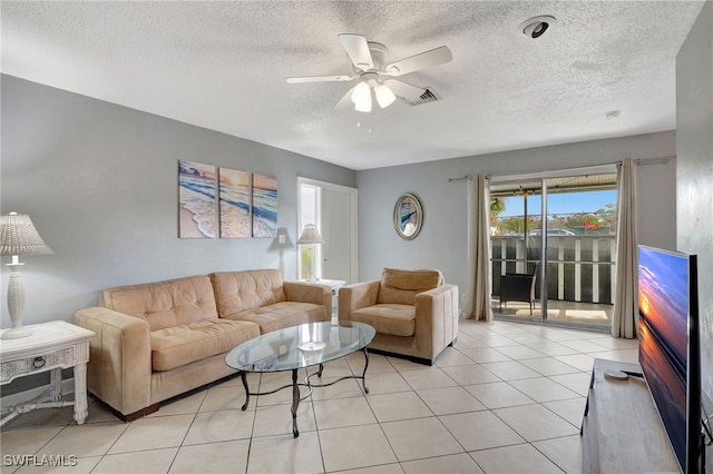 tiled living room featuring a textured ceiling and ceiling fan