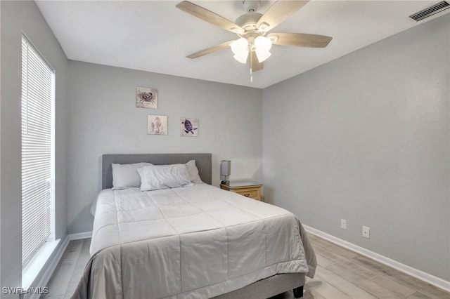 bedroom with light hardwood / wood-style floors and ceiling fan