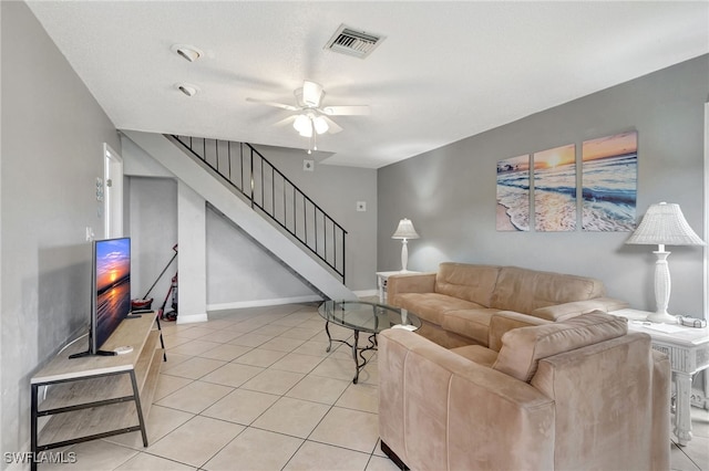 tiled living room featuring ceiling fan