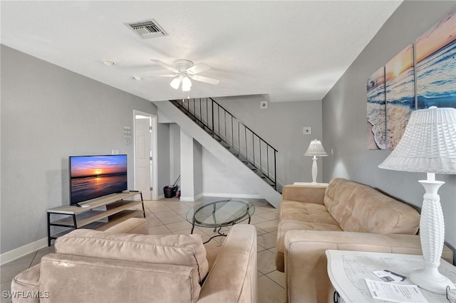 living room featuring light tile patterned floors and ceiling fan