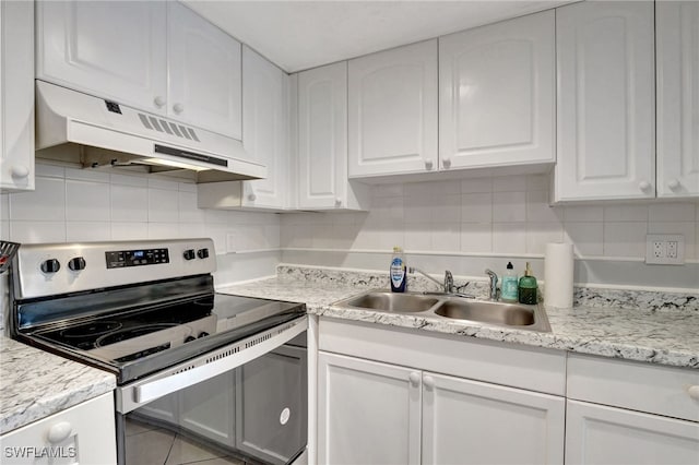 kitchen featuring tasteful backsplash, white cabinetry, sink, and electric range