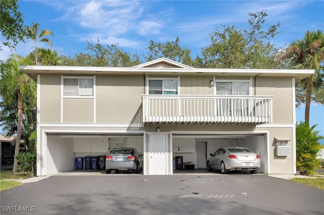 view of front facade with a garage and a balcony