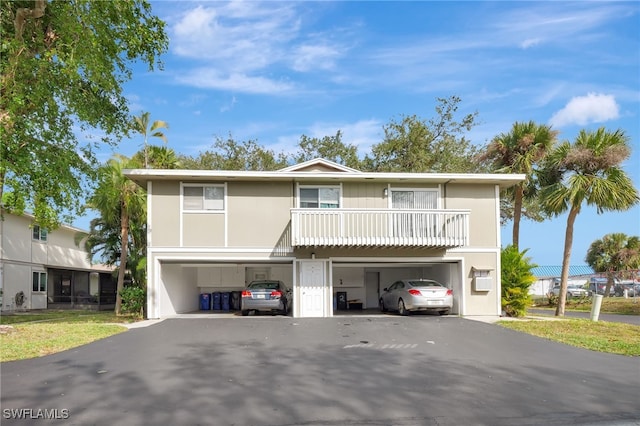 view of front of home featuring a garage and a balcony