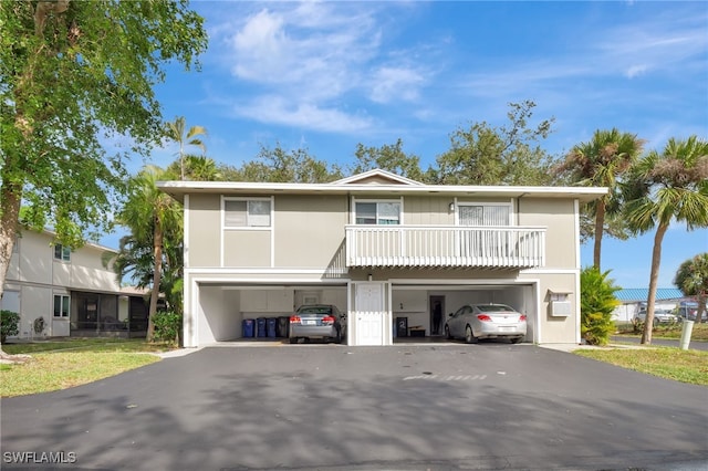 view of front of home with a garage and a balcony