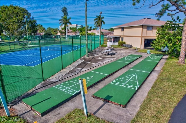 view of community featuring tennis court