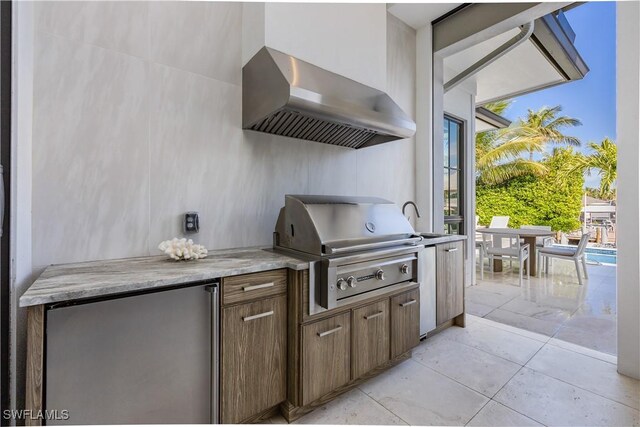 view of patio with area for grilling, sink, and exterior kitchen