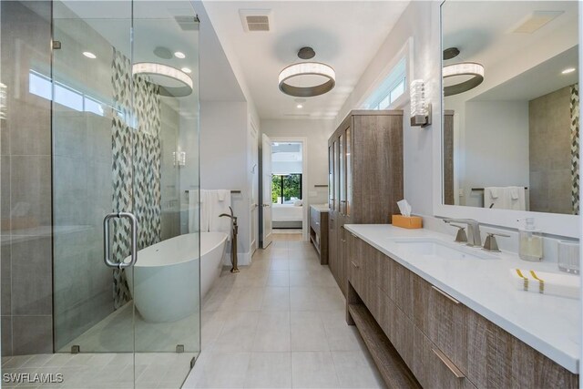 bathroom with vanity, tile patterned floors, and independent shower and bath