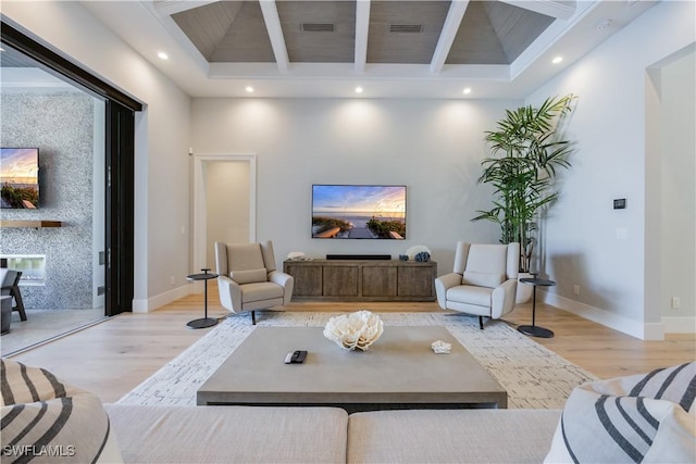 living room with wood ceiling, light hardwood / wood-style floors, and beamed ceiling