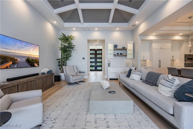 living room with a high ceiling and hardwood / wood-style flooring