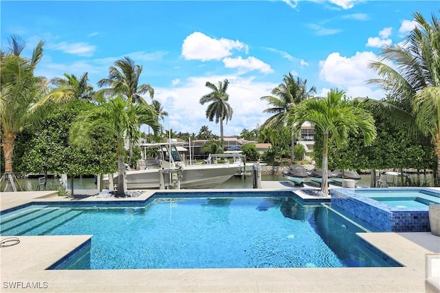 view of swimming pool featuring a pool with connected hot tub and a water view