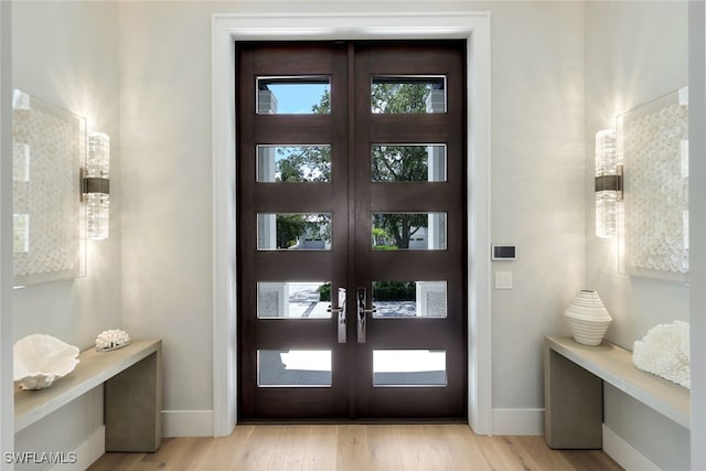 interior space with light hardwood / wood-style floors and french doors