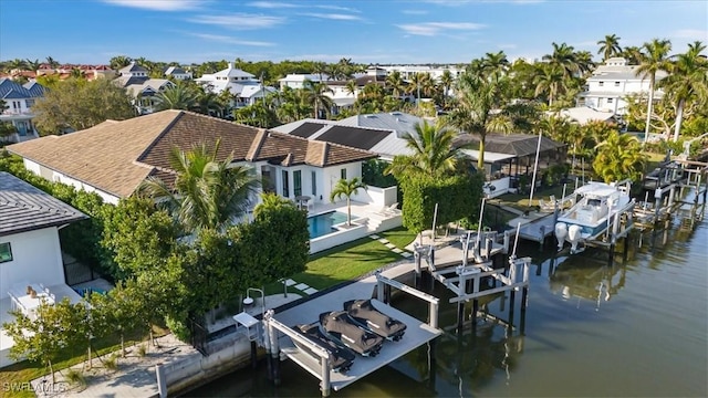 drone / aerial view featuring a water view and a residential view