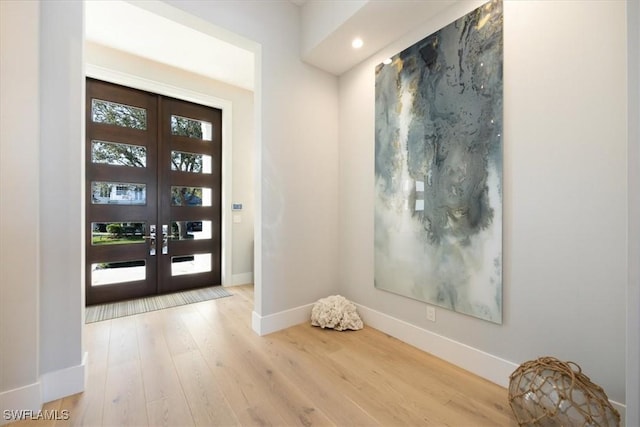 entrance foyer with french doors, light wood finished floors, recessed lighting, and baseboards